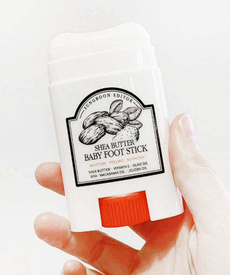 SUNGBOON EDITOR Shea Butter Baby Foot Stick held in hand for moisturizing and nourishing feet