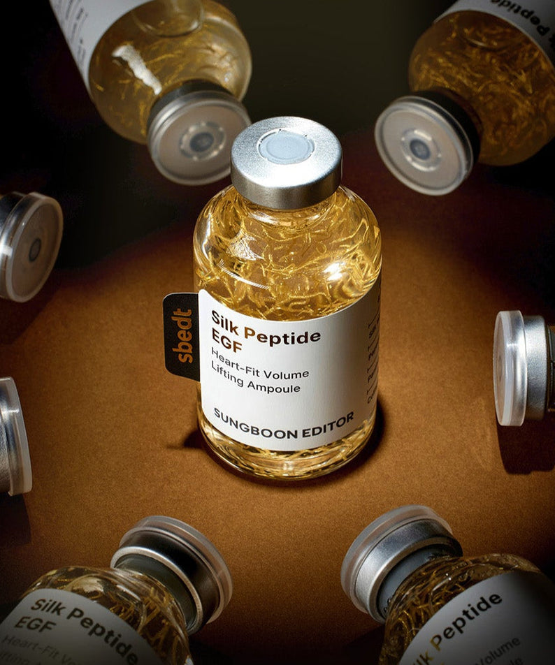 SUNGBOON EDITOR Silk Peptide EGF Heart-Fit Volume Lifting Ampoule 40ml bottles displayed artistically on a dark background.