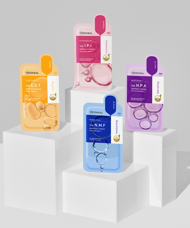 Display of four MEDIHEAL Ampoule Mask varieties on white podiums for skincare.