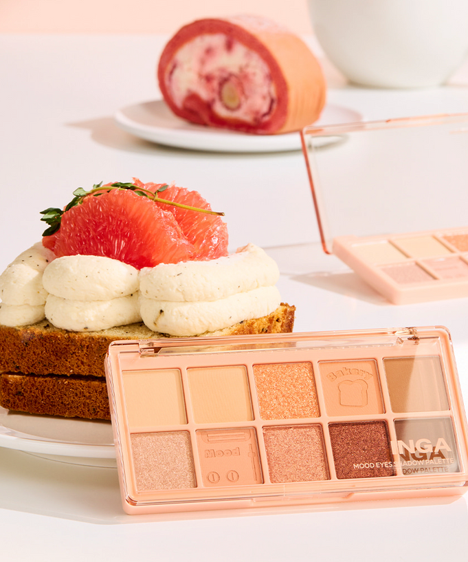 INGA Mood Eyes Shadow Palette featuring nude and peach eyeshadow shades, displayed in a creative dessert-themed setting with cake.