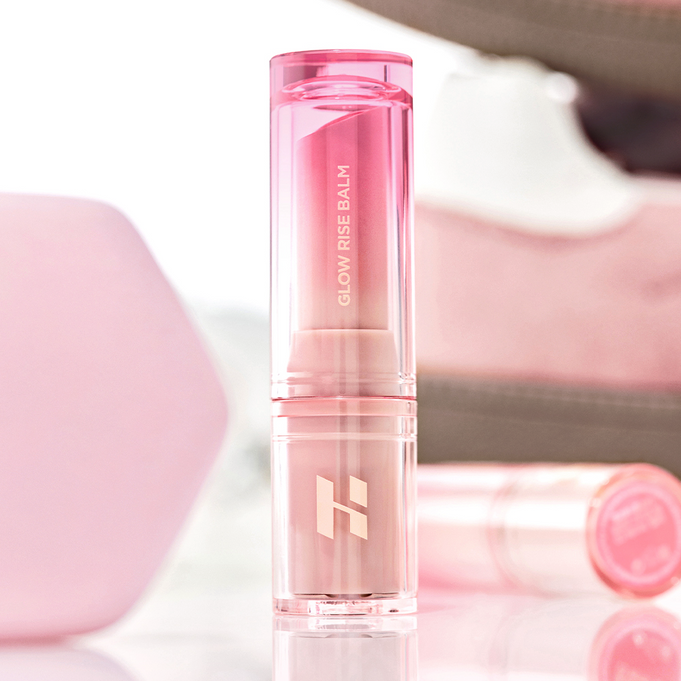 HOLIKA HOLIKA Glow Rise Balm 8 colors in a sleek pink tube, showcased in a makeup setting.
