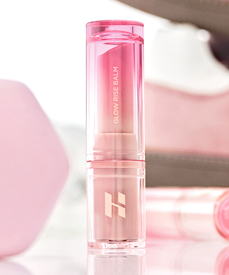 HOLIKA HOLIKA Glow Rise Balm 8 colors in a sleek pink tube, showcased in a makeup setting.