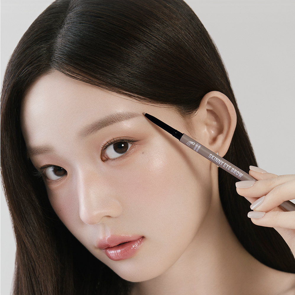 Woman applying HOLIKA HOLIKA Wonder Drawing Skinny Eyebrow 0.05g to enhance brow definition.