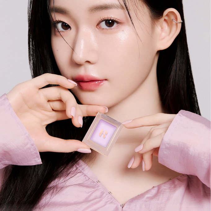 Model holding HOLIKA HOLIKA My Favorite Peace Concealer, showcasing the product's sleek design and packaging.