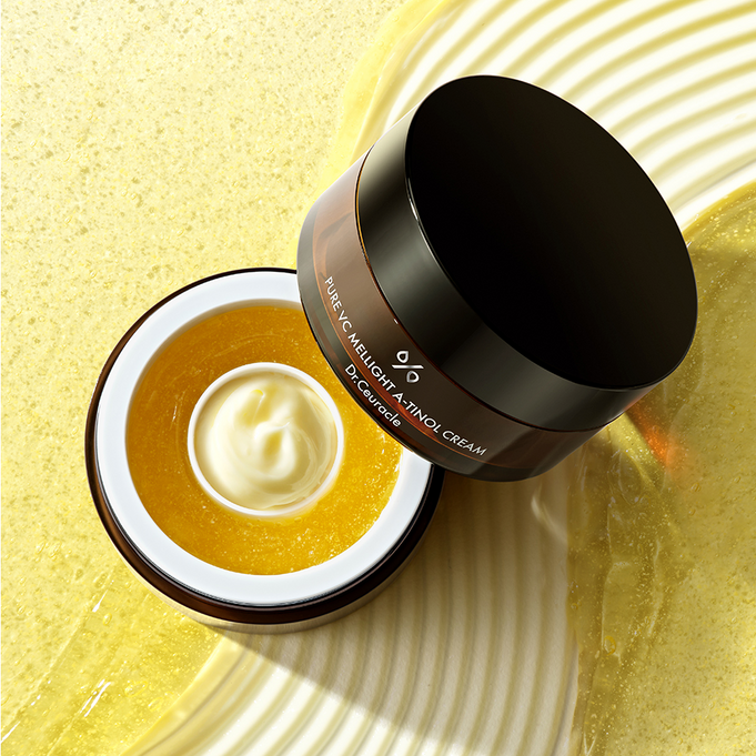 Open jar of DR.CEURACLE Pure VC Mellight A-Tinol Cream 70g on textured background