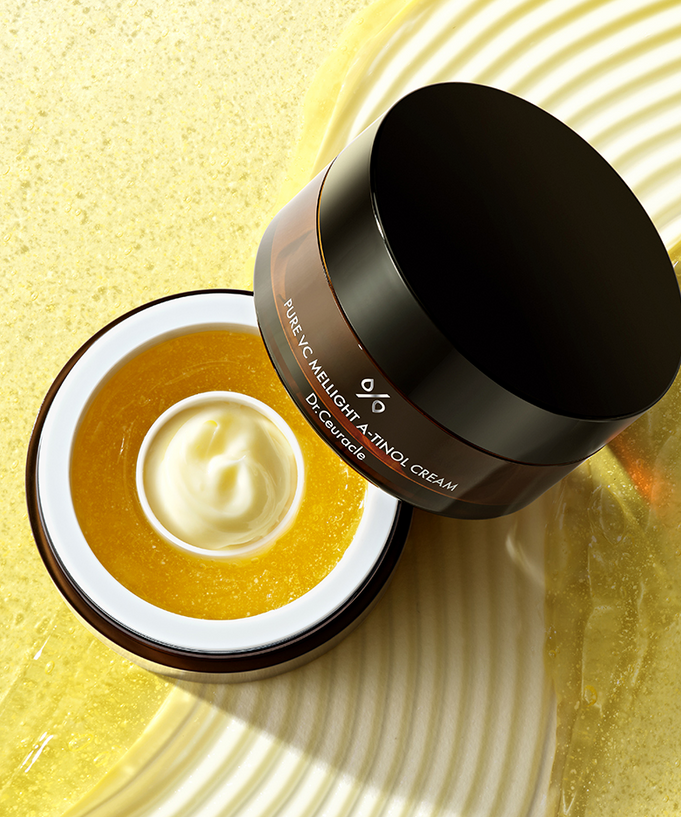 Open jar of DR.CEURACLE Pure VC Mellight A-Tinol Cream 70g on textured background