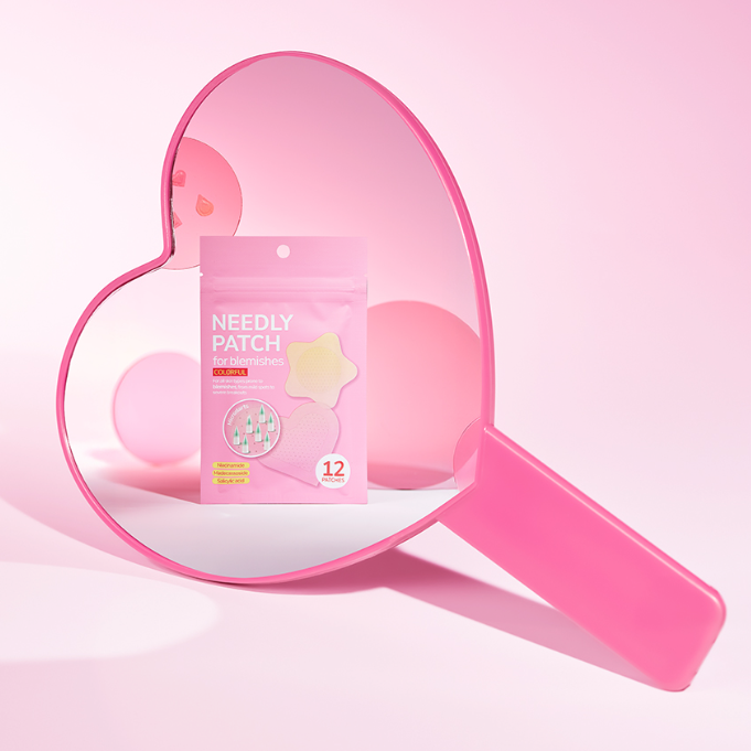 NEEDLY Patch for Blemishes Colorful 12 Patches displayed in pink heart-shaped mirror.