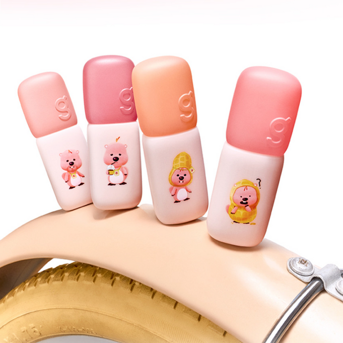 COLORGRAM Colorgram Nude Blur Tint AD 5g in various shades displayed on a bicycle wheel, perfect for natural makeup looks.