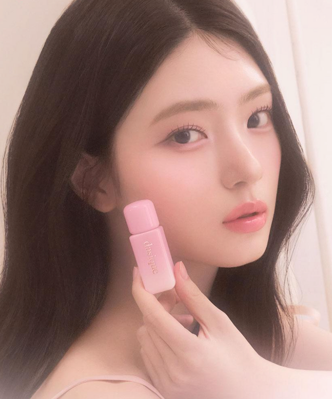 Model holding DASIQUE Silky Veil Blush with a soft-focus effect, highlighting the product's smooth, silky finish on skin.