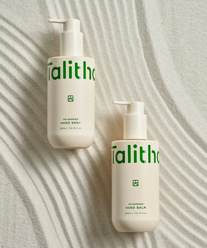 TALITHA KOUM HM+Barrier Hand Wash 300ml and Hand Balm bottles on a textured surface