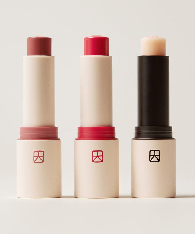 Three shades of TALITHA KOUM Lipcure Balmtik lip balm tubes displayed upright on a neutral background.