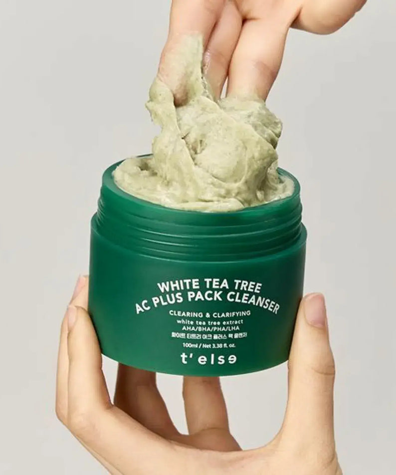 Person holding open jar of T'ELSE White Tea Tree Arc Plus Pack Cleanser 100ml with product on fingers.