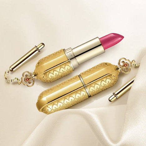 THE WHOO Gong Jin Hyang Mi Luxury Lipstick in elegant gold case with pink hue, showcased on a silky fabric for a luxurious appeal.