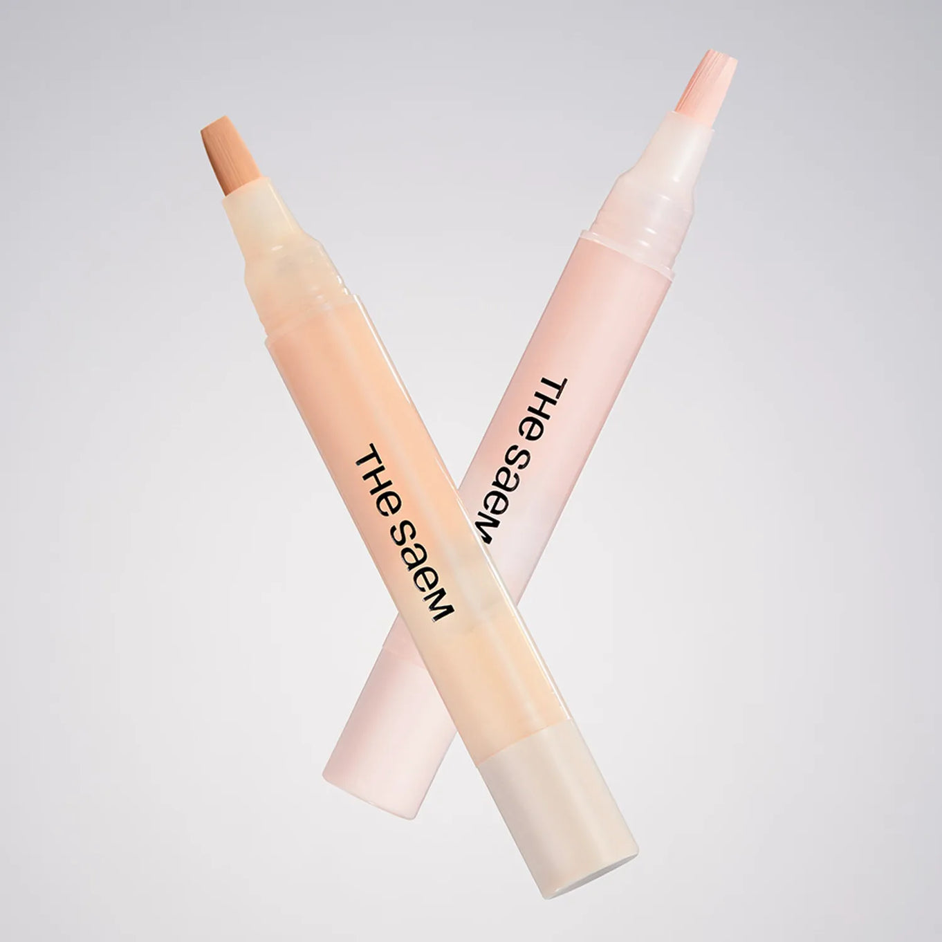 THE SAEM Cover Perfection Pen Concealer showcasing two shades with brush applicators against a neutral background.