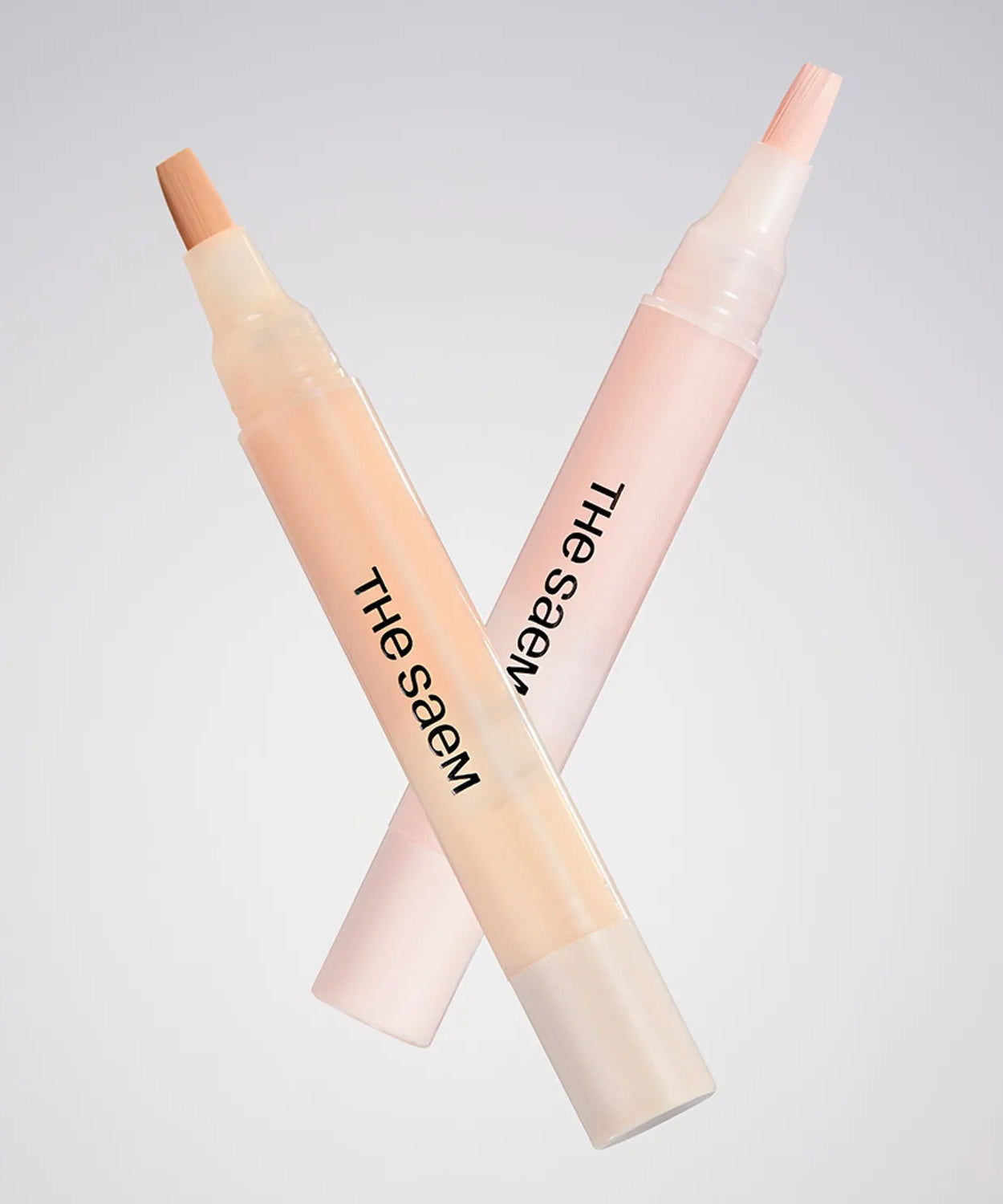 THE SAEM Cover Perfection Pen Concealer showcasing two shades with brush applicators against a neutral background.