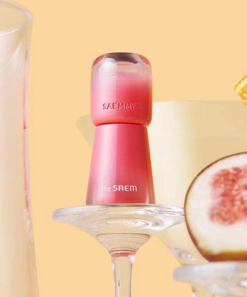 THE SAEM Saemmy's Aid Shot Tint in a vibrant display with fruits and drinks on a pastel background.