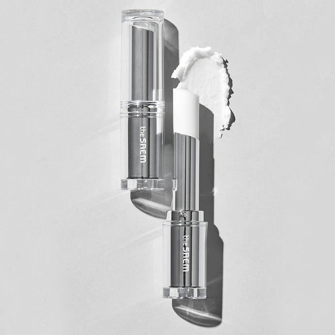 THE SAEM Soft Blurring Primer Lip Balm in clear packaging on monochrome background, showcasing texture and color.