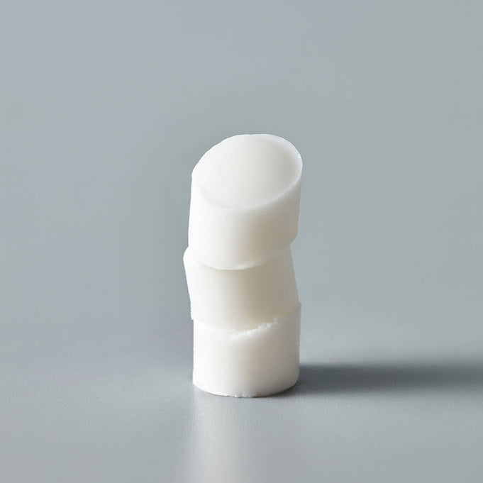 THE SAEM Soft Blurring Primer Lip Balm displayed on a grey background, emphasizing its smooth texture and creamy consistency.