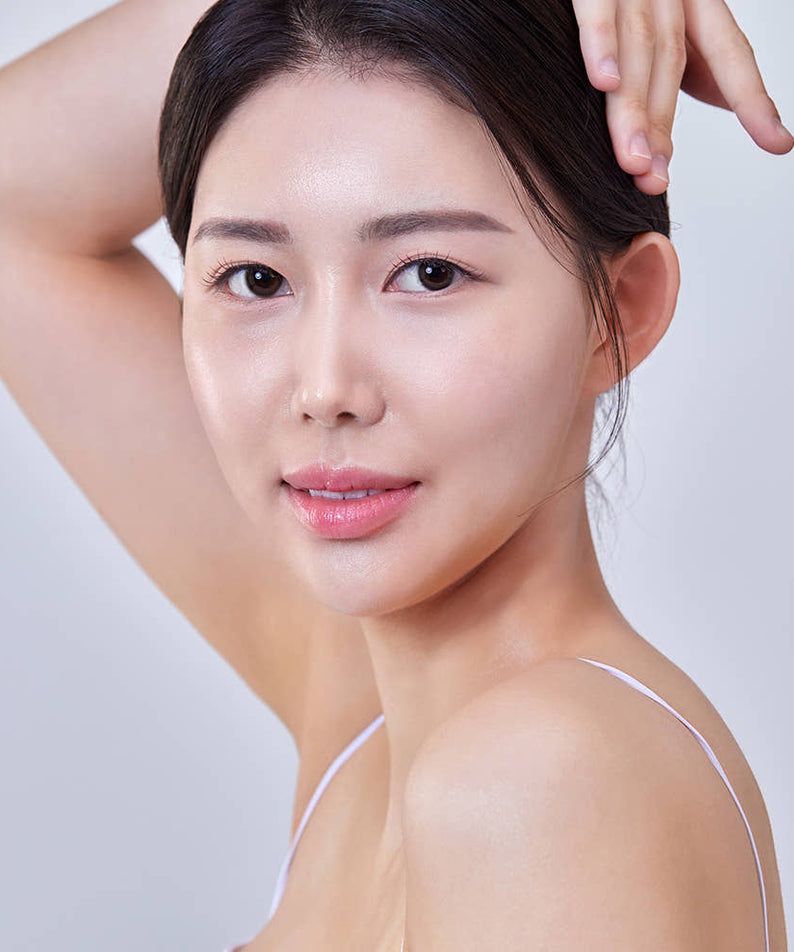 Smiling woman with clear skin showcasing results of THE SAEM Temptation Age Return Toner 130ml.