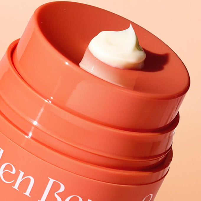 Close-up of THE SAEM Urban Eco Golden Berry C Eye Cream 30ml showing cream texture in orange container.