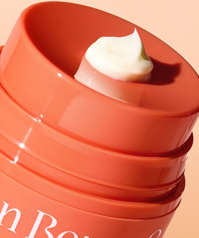Close-up of THE SAEM Urban Eco Golden Berry C Eye Cream 30ml showing cream texture in orange container.