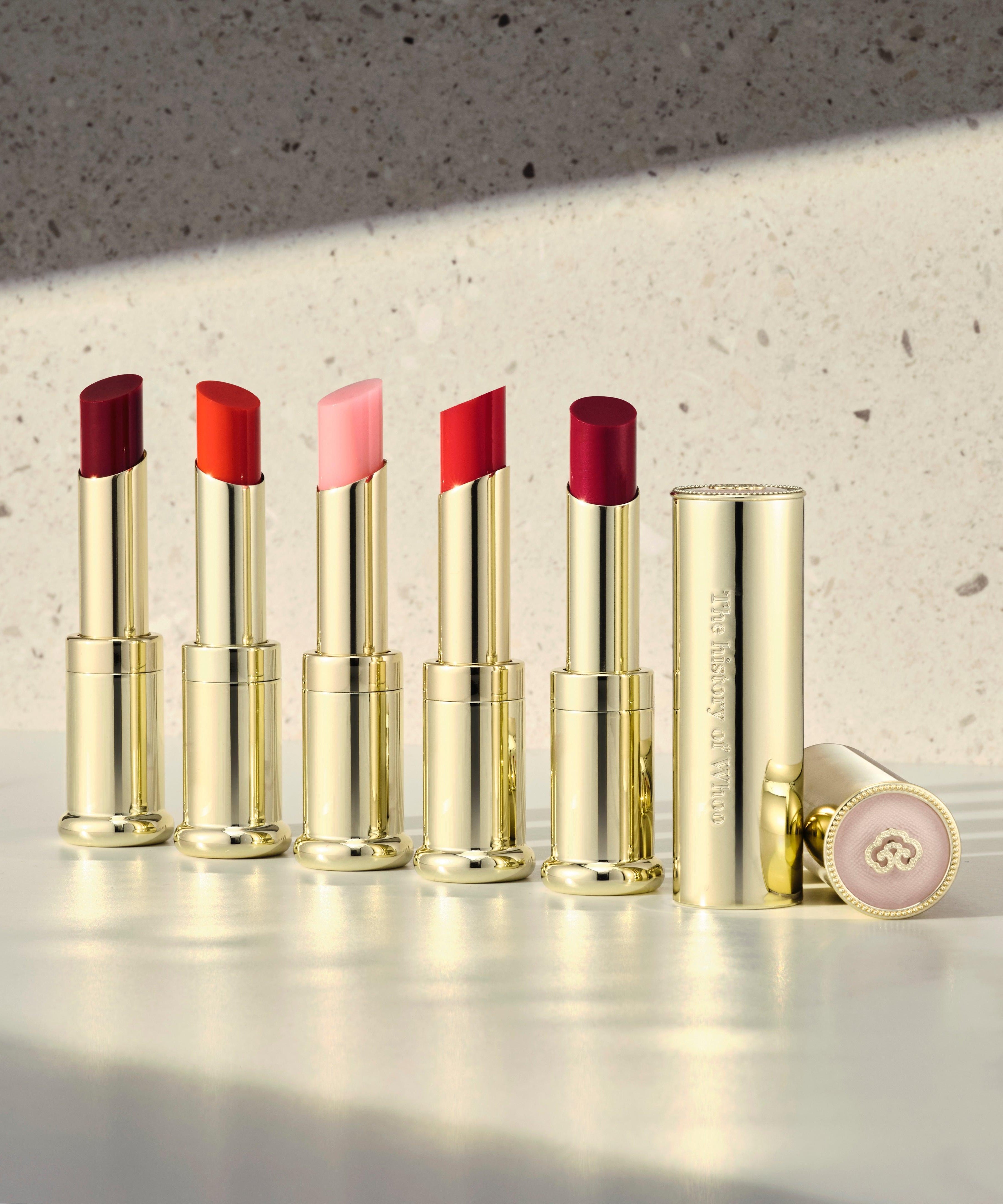 THE WHOO Gong Jin Hyang Mi Glow Lip Balm 3.3g in multiple shades on a marble surface