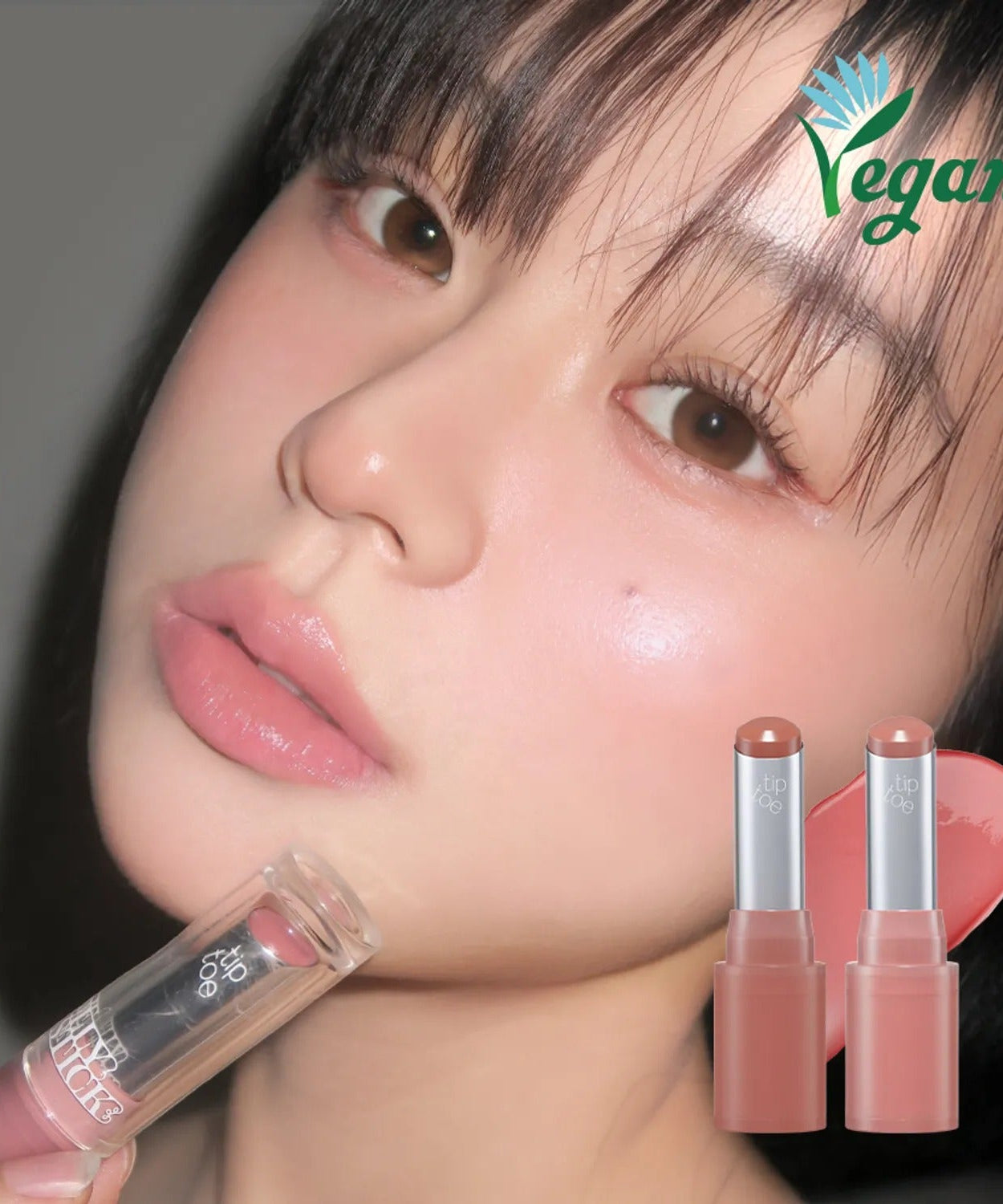 Woman applying TIP TOE Jelly Stick Plan vegan lip product showcasing natural glow and beauty.