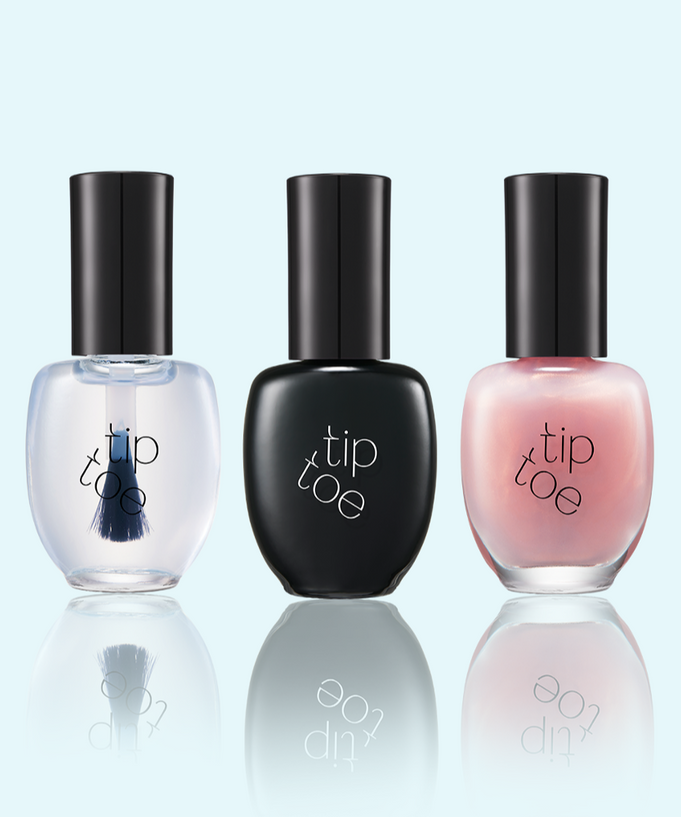 Set of three TIP TOE Sheer Topcoat Nail Polish bottles in different shades on a reflective surface.