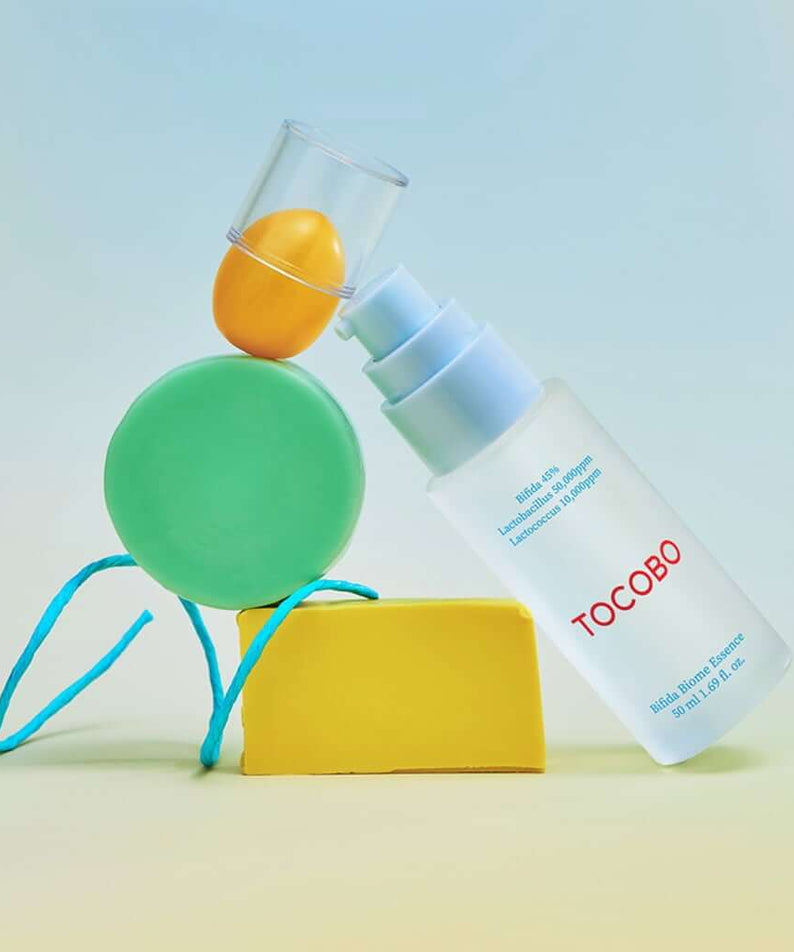 TOCOBO Bifida Biome Eessence product bottle with colorful abstract design background