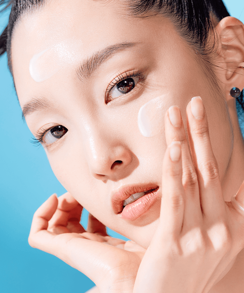 Woman applying TOCOBO Bio Watery Sun Cream for skincare