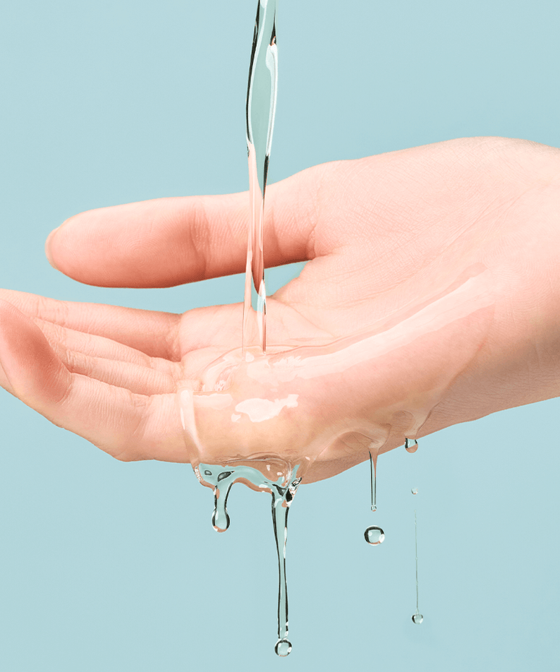 Pouring TOCOBO Cica Calming Aqua Toner onto hand against blue background