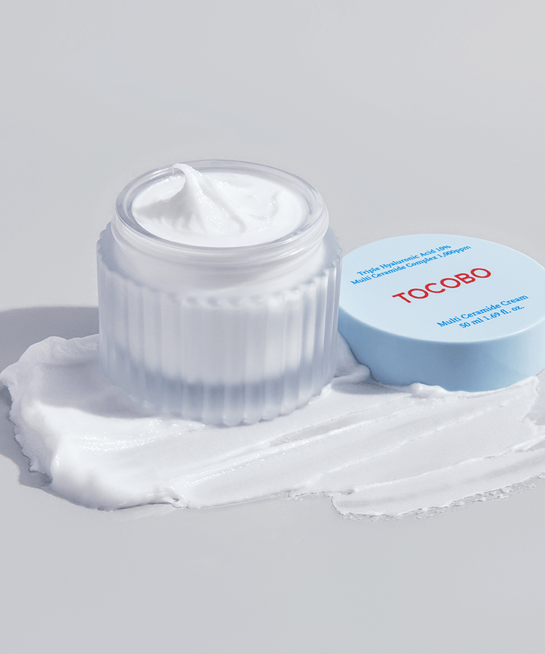 TOCOBO Multi Caramide Cream in open jar with lid on texture smear.