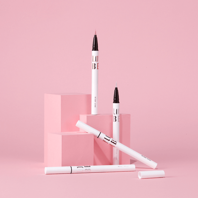 TONY MOLY Aegyo Beam Glitter Liner displayed with pink geometric blocks
