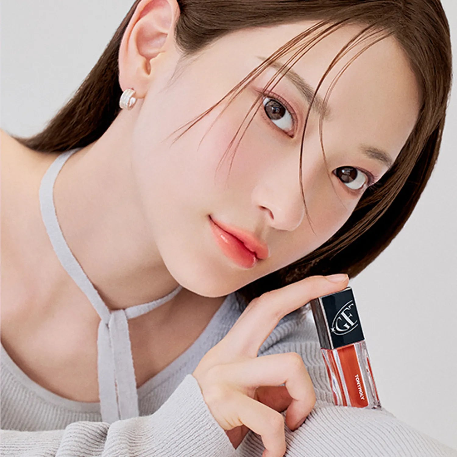 Model holding TONY MOLY Get It Tint Colorful Water lip tint