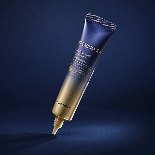 TONYMOLY Premium RX Swallow's Nest Eye Cream 30ml in dark blue and gold packaging on a dark blue background.