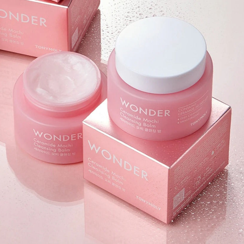 TONYMOLY Wonder Ceramide Mochi Cleansing Balm 100ml on pink reflective surface with open lid and packaging.