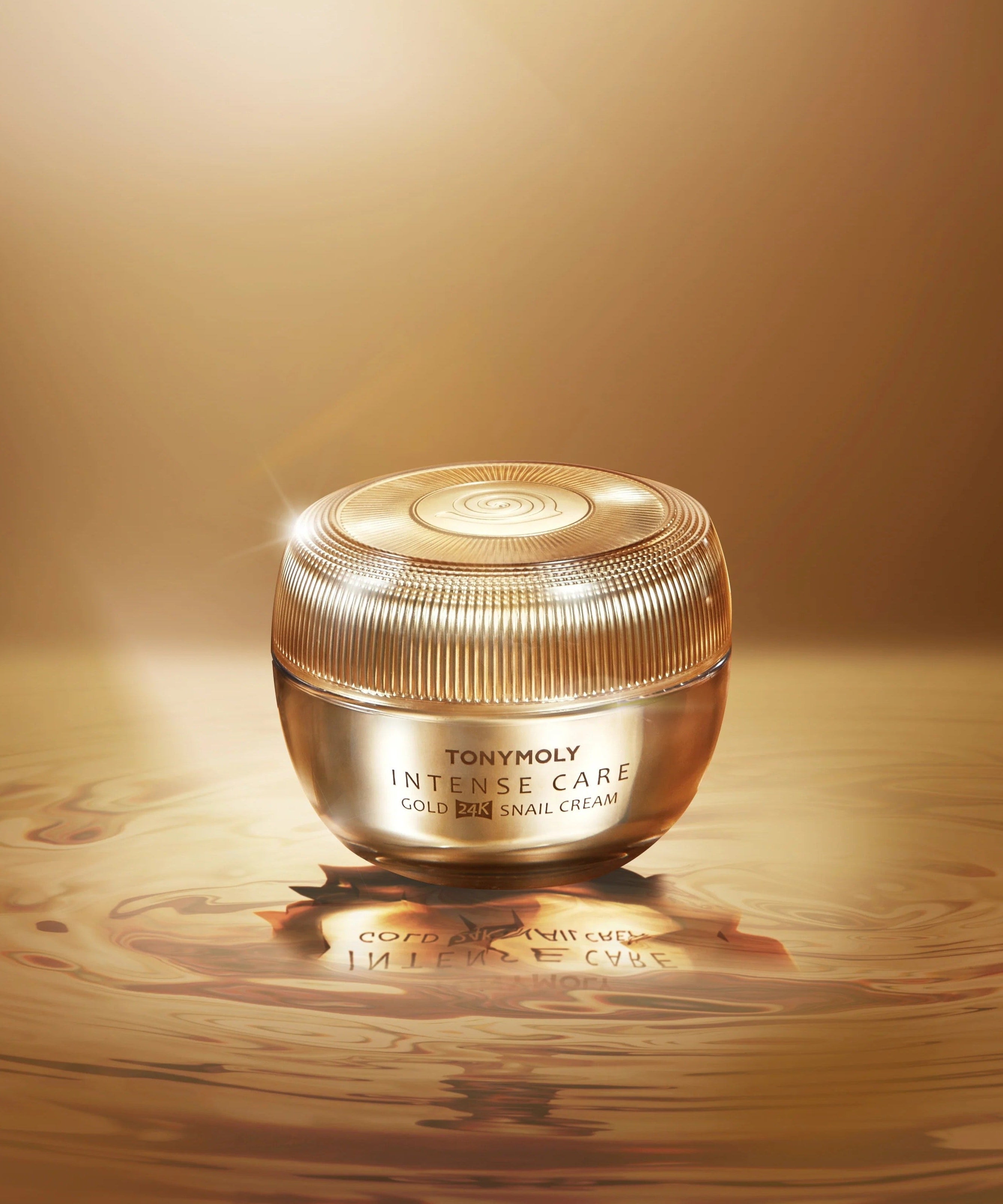 TONYMOLY Intense Care Gold24K Snail Cream 45ml jar on a glossy gold surface