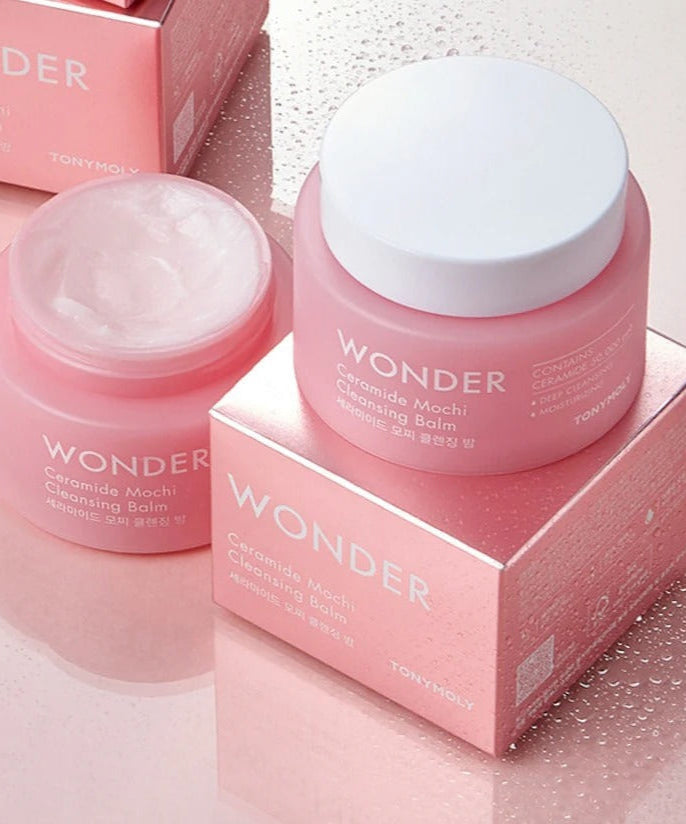 TONYMOLY Wonder Ceramide Mochi Cleansing Balm 100ml on pink reflective surface with open lid and packaging.