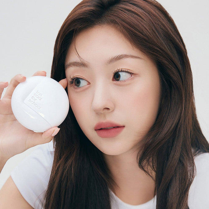Woman holding TOO COOL FOR SCHOOL Fixing Cover Fit Cushion [Product + Refill] near her face