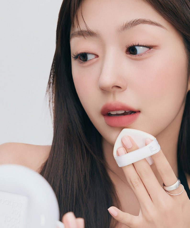 Woman applying TOO COOL FOR SCHOOL Fixing Cover Fit Cushion [Product + Refill] with compact in hand