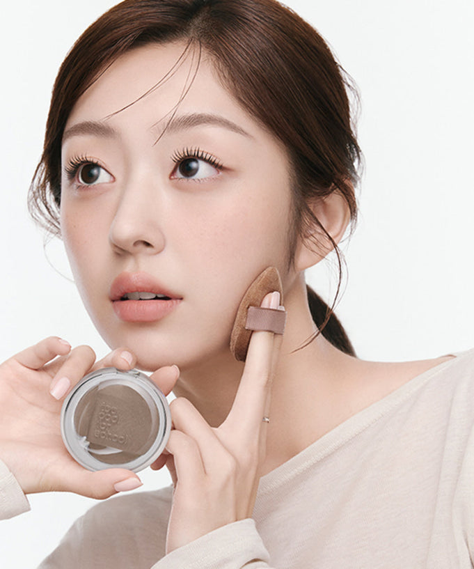 Woman applying TOO COOL FOR SCHOOL Veiled Contour makeup on face