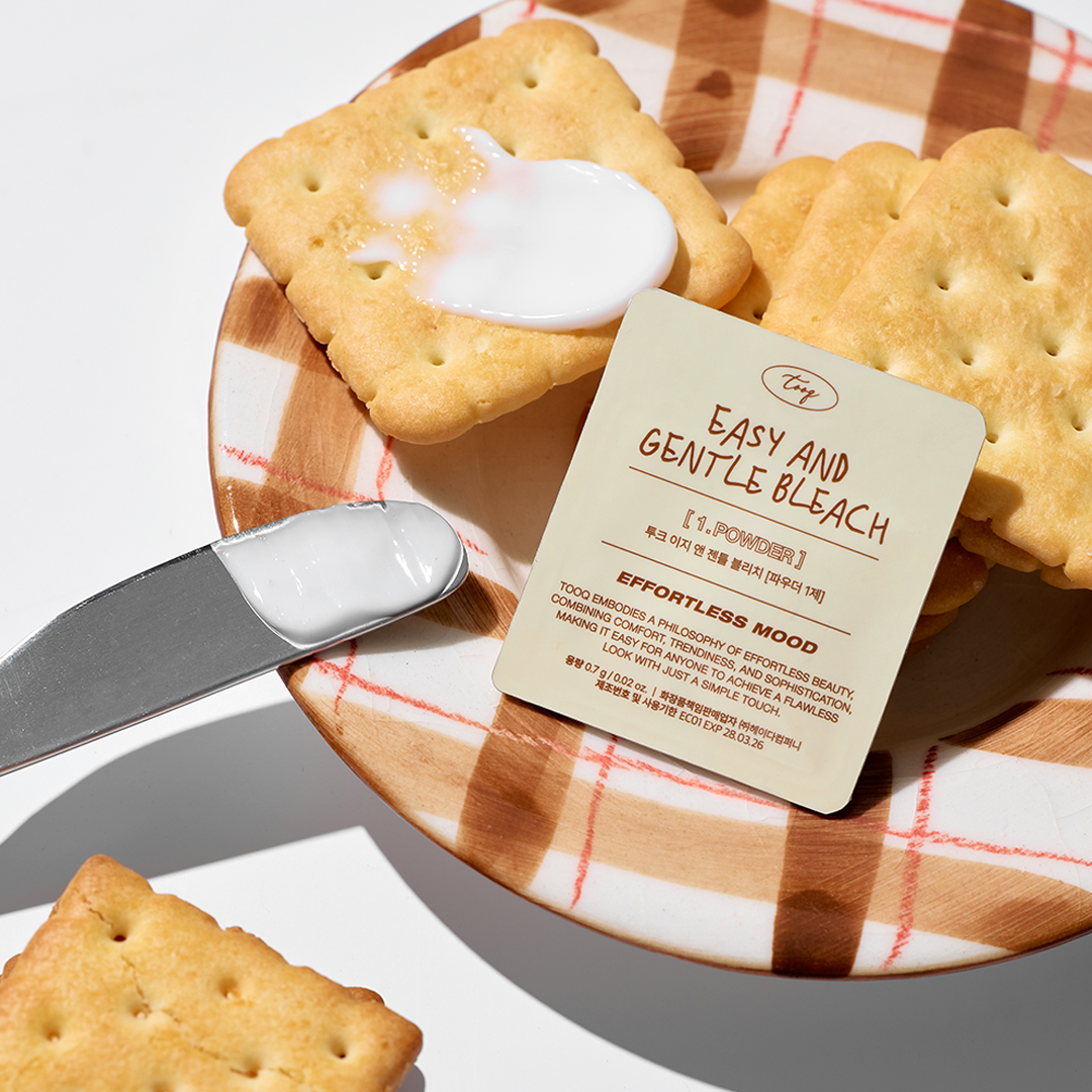 TOOQ Easy And Gentle Bleach packaging with a knife, crackers, and cream, marketing a gentle bleaching product by TOOQ.