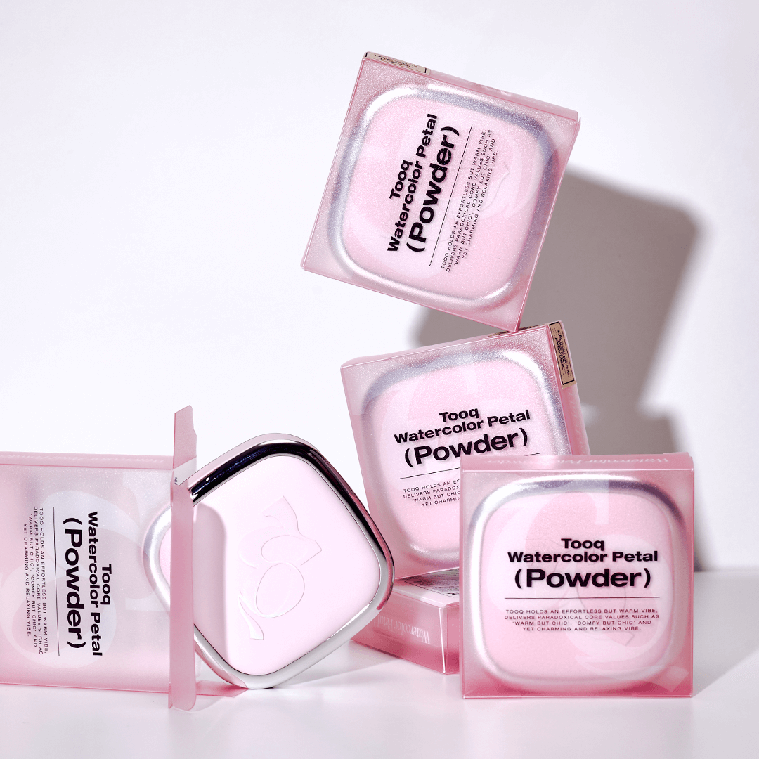 TOOQ Water Color Petal Powder packaging with multiple pink boxes stacked and open, showcasing the elegant design.