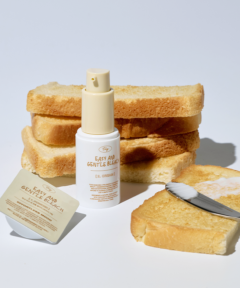 TOOQ Easy And Gentle Bleach bottle surrounded by toast and a brush on a white background.