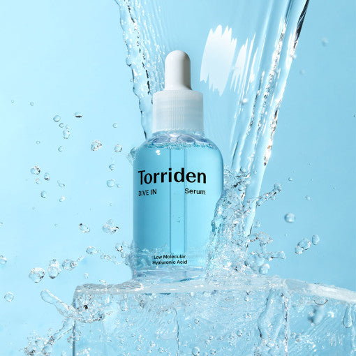 TORRIDEN Dive In Low Molecular Hyaluronic Acid Serum 50ml bottle in splashing water on blue background.