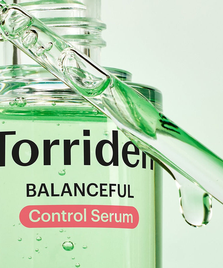 Close-up of TORRIDEN Balanced Cica Control Serum 50ml with dropper and green liquid texture.