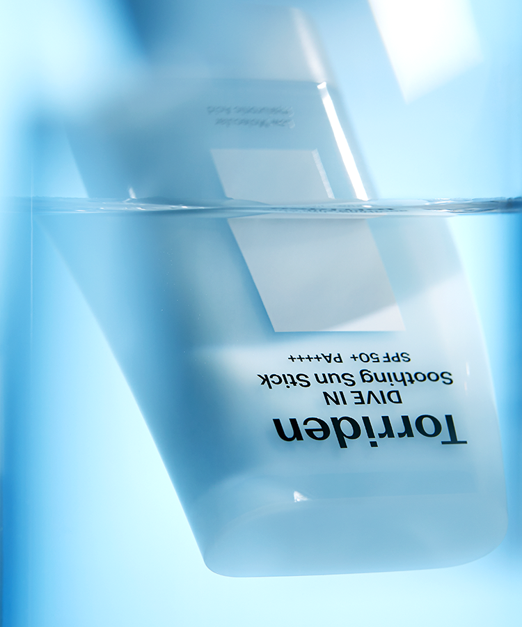 TORRIDEN Dive In Soothing Sun Stick SPF50+PA++++ 19g submerged in water.