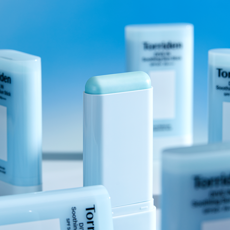 Close-up of TORRIDEN Dive In Soothing Sun Stick SPF50+PA++++ 19g with multiple sun sticks in the background.