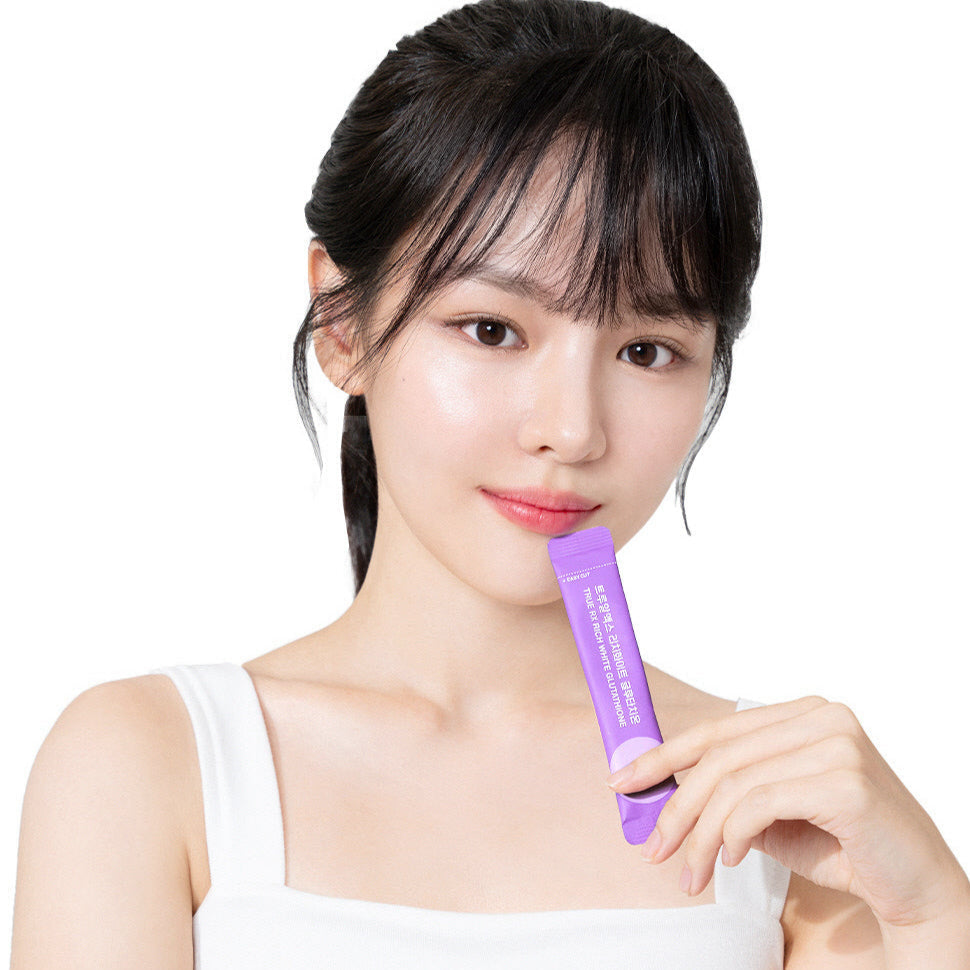 Woman holding TRUE RX Rich White Glutathione stick from 10 packs