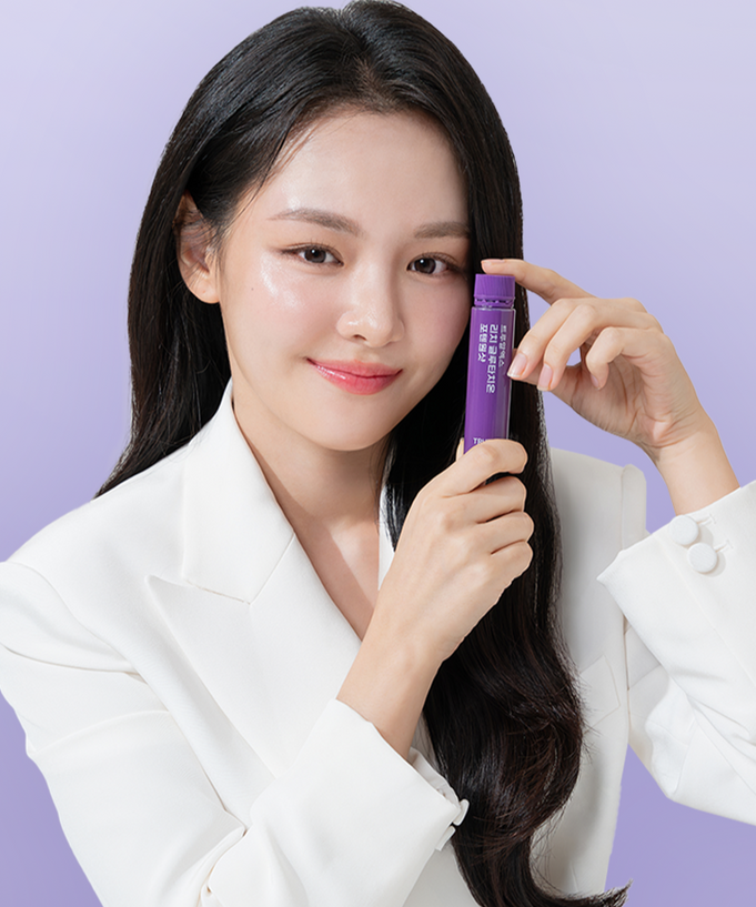 Woman holding TRUE RX Rich Glutathione Potent One Shot 1 box (8 bottles) against a light purple background